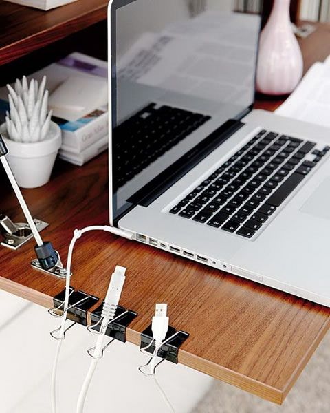 Attach binder clips on the side of the desk to keep cables and cords organized